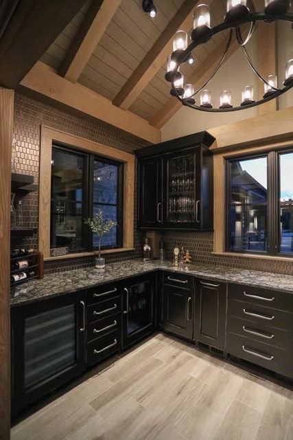 Black custom bar cabinetry under timber beams