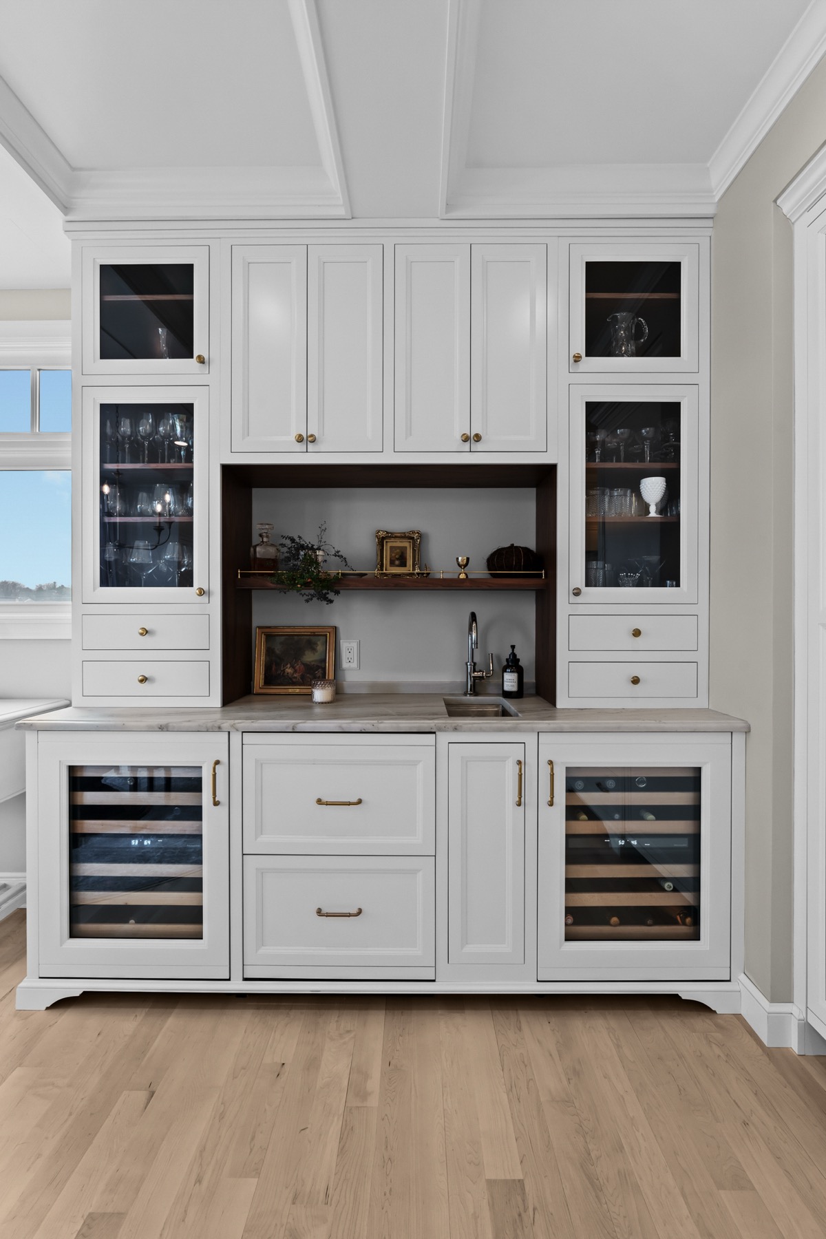 White butler pantry built-in with glass uppers and wine refrigerators