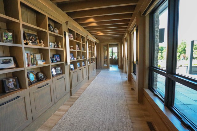 Hallway lined with custom built-in shelving