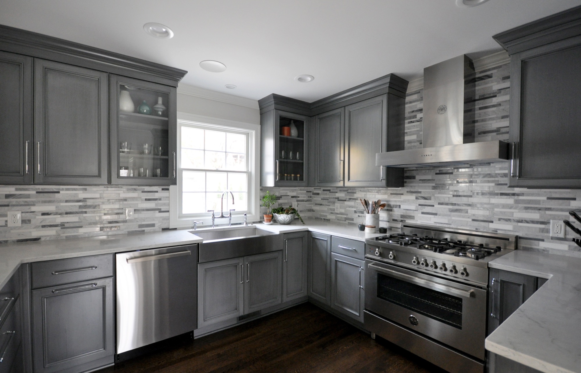 Grey custom kitchen with marble backsplash and pro range