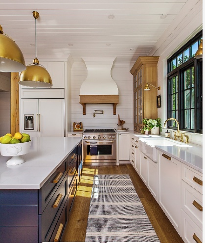 White and navy kitchen with brass pendants